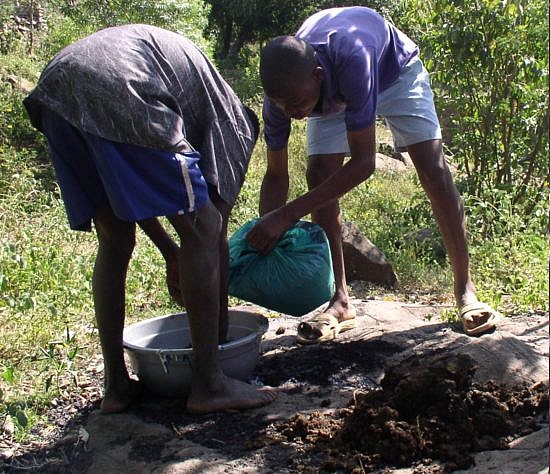 Picture: Mixing charcoal dust with cow dung