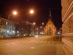 church from proximity, space around statue at left